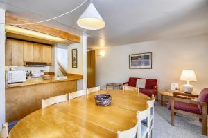 a dining room and kitchen with a table and chairs at Notchbrook 28AB in Stowe