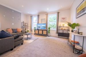 a living room with a couch and a flat screen tv at The Lytham Retreat - New! Spacious & Luxurious in Lytham St Annes
