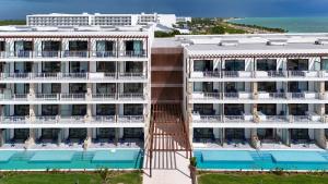 an aerial view of a hotel with a swimming pool at Ocean Allure Costa Mujeres - Adults Only - All Inclusive in Costa Mujeres