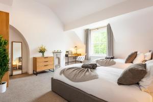 a large bedroom with two beds and a desk at The Lytham Retreat - New! Spacious & Luxurious in Lytham St Annes