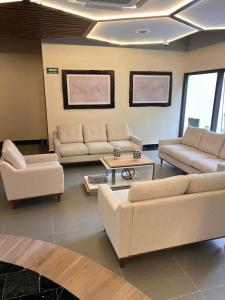 a living room with two couches and a table at Hotel Mundo Maya Tulum Aeropuerto in Tulum +56 photos