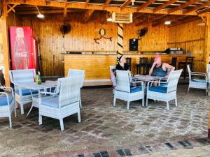 un homme assis à une table dans un restaurant dans l'établissement Turtles Beach resort hourghada Studio view sea view pool private beach jacuzzi pools air-conditioned restaurant on the beach jacuzzi security and a large sunny balcony, à Hurghada