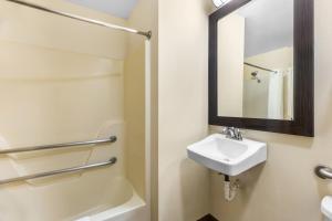 a bathroom with a sink and a mirror at Travel Inn and Suites- Sikeston Miner I-55 exit-67 in Sikeston +29 photos