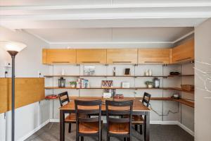 a dining room with a wooden table and chairs at Notchbrook 5 Apt. in Stowe +28 photos