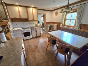 a kitchen with a wooden table and a dining room at Ferienwohnung WIEKI in Gmünd in Kärnten