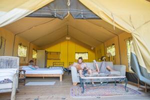 a man laying on a couch in a tent at Seuls au monde in Varen +16 photos