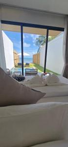 a room with three beds and a view of the ocean at ThreeTreesSamuiPoolVilla in Ban Thung +11 photos
