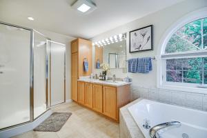 a bathroom with a tub and a shower and a sink at Pet-Friendly Home with Hot Tub Near Cranmore! in Conway +34 photos