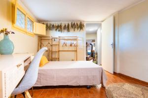 a bedroom with a bed and a table and chairs at En las montañas de Benicassim in Las Villas
