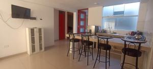 a kitchen with bar stools and a kitchen with a sink at Apartment, with kitchen, garage and laundry in Tacna