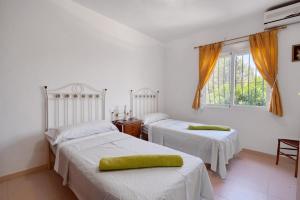 a bedroom with two beds and a window at Tossal Gros in La Font D´En Carròs +18 photos