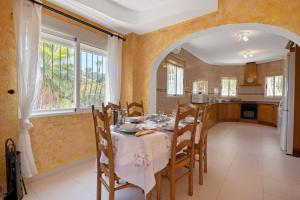 a kitchen and dining room with a table and chairs at Tossal Gros in La Font D´En Carròs