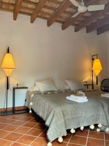 a bedroom with two beds and two lamps at Cortijo Bablou in Arcos de la Frontera +67 photos