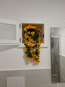 a bunch of yellow flowers on a wall at Eos Lipari in Lipari +19 photos