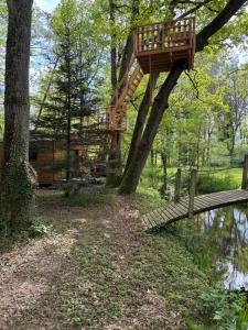 a tree house in the middle of a forest at Les Chalets Horizon in Saint-Just-de-Claix