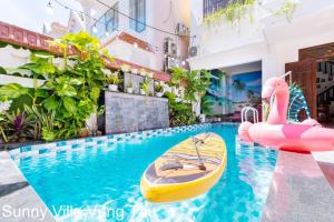 a pool with a paddle board and an inflatable pool toy at Sunny Villa 109 Võ Thị Sáu in Vung Tau +42 photos