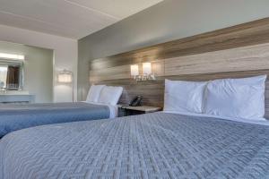 a hotel room with two beds with white pillows at Americas Best Value Inn Stearns, KY in Stearns