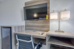 a room with a desk with a tv and a chair at Americas Best Value Inn Stearns, KY in Stearns