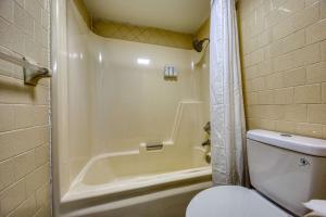 a bathroom with a tub and a toilet and a shower at Americas Best Value Inn Stearns, KY in Stearns