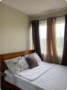 Ένα ή περισσότερα κρεβάτια σε δωμάτιο στο GusBek Condo Unit San Remo Oasis Cebu +10 φωτογραφίες