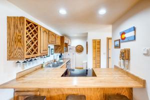a large kitchen with wooden cabinets and a large island at Timber Ridge 203 in Silverthorne