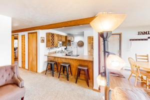 a kitchen and living room with a table and chairs at Timber Ridge 203 in Silverthorne