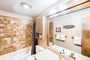 a bathroom with a tub and a sink and a shower at Timber Ridge 203 in Silverthorne +12 photos