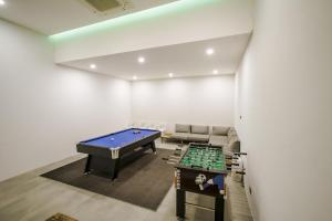 a room with a pool table and a couch at Yamu Hills Panoramic Ocean View 6 Bed Luxury Vila in Phuket Town