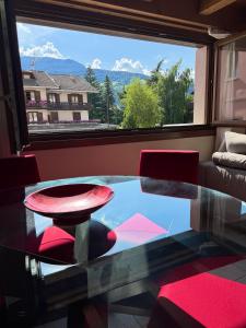 a glass table in a room with a large window at Gloria Holiday Home Bormio N10 in Bormio