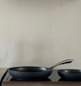 two black bowls sitting on a table with a spoon at Entire Apartment 140m2 near Syvota and Parga in Makrochóra +34 photos