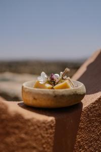 a bowl of food sitting on top of a wall at Berber Beldi Camp in Imsouane