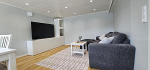 a living room with a couch and a flat screen tv at Apartment in Skärhamn within walking distance to the beach in Toftenäs