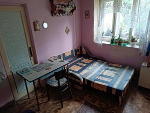 a room with a bed and a table and a window at biofarma in Chrudim