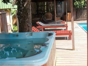 a blue bath tub sitting next to a tree at Hôtel Restaurant Gites Kribi in Kribi