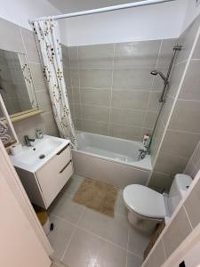 a bathroom with a toilet and a tub and a sink at Le Cocon in Nice