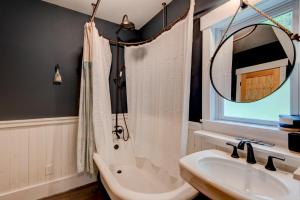 a bathroom with a tub and a sink and a mirror at Orchard House in Banner Elk +67 photos
