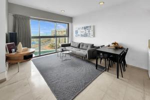 a living room with a couch and a table at Okeanos Sea Loft in Herzliya B