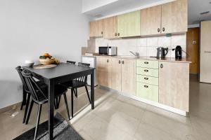 a kitchen with a table and chairs in a room at Okeanos Sea Loft in Herzliya B