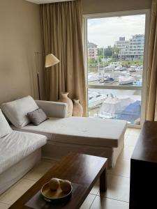 a living room with a couch and a large window at CONDOMINIOS DE BAHIA GRANDE NORDELTA!! Tigre in Tigre