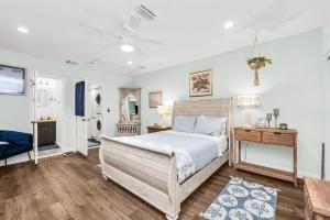 a bedroom with a bed and a nightstand and a bed sidx sidx sidx sidx at Relaxing Salt Pool & Spa, Walk to Key Lime House! in Lantana +48 photos