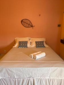 a bed with two towels on top of it at Parnaíba Hostel in Parnaíba
