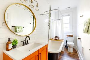 a bathroom with a sink and a mirror at Short North Convention Private Parking Pets! in Columbus +111 photos