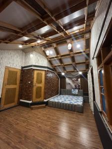 a large room with a bed in the middle of it at The Mool Farm and Living in Tangmarg