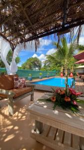 a resort with a pool and a couch and a table at Charming apartment in Albion with shared pool, 20.3 m² in Albion