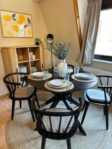 a dining room with a table with four chairs at Elbflorenz in Bad Schandau