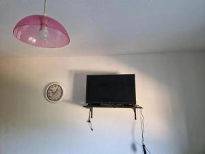 a flat screen tv sitting on a table in a room at Studio confortable avec vue sur la ville à Dole, 25 m² in Dole