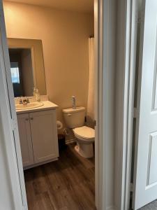 a bathroom with a toilet and a sink at Beautiful New Build by Coachella Fest in Coachella +18 photos