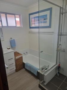 a bathroom with a shower and a bath tub at Ocean Drive Home: 3 bedroom 70s-inspired… - 19110 in Bunbury +21 photos