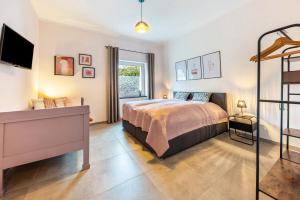 a bedroom with a bed and a tv on a wall at Suiten im Alten Berghotel Johanna in Niedersalwey