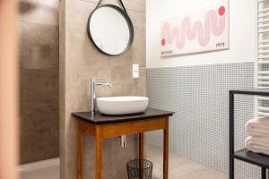 a bathroom with a sink and a mirror at Suiten im Alten Berghotel Johanna in Niedersalwey +23 photos